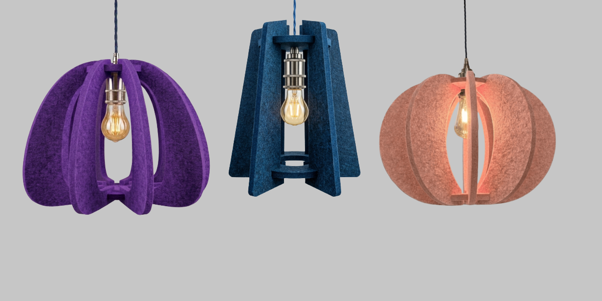 Three unique pendant lights in purple, blue, and pink on a gray background